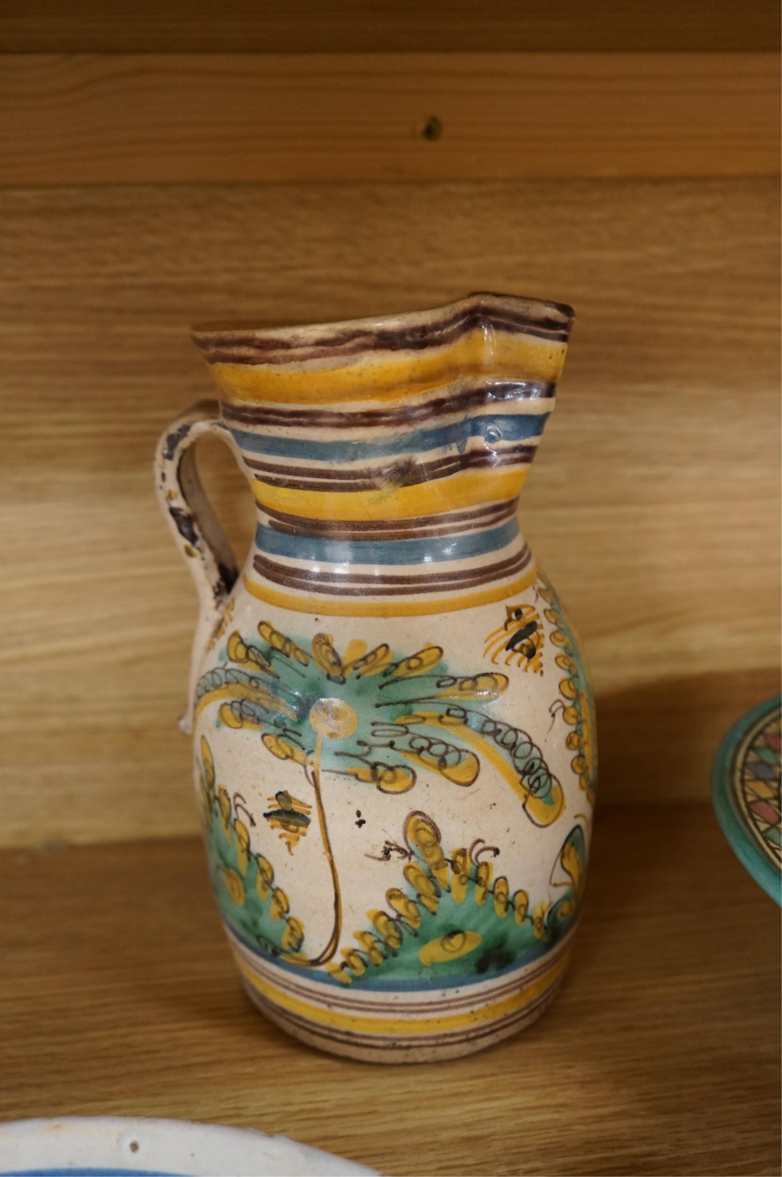 A late 17th century Spanish tin glazed jug together with Moroccan and pottery bowls and dishes (5). Jug 26cm high.